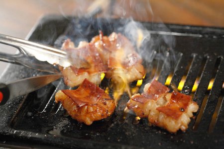 Photo for Close up view of delicious Asian food, Japanese Offal, marinated horumon on grill - Royalty Free Image