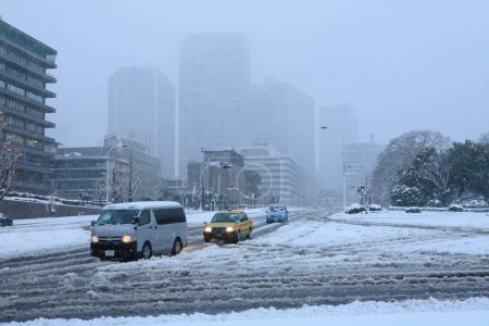 Photo for Snow covered cars and road in city, heavy snowfall in winter - Royalty Free Image