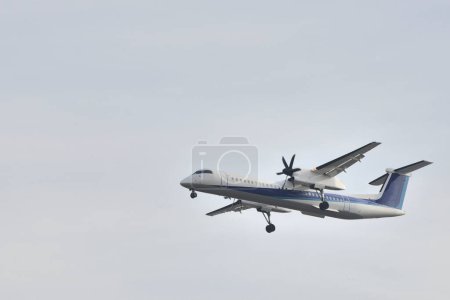 Photo for Modern airplane flying in blue sky - Royalty Free Image