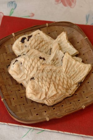 Photo for Taiyaki, a fish-shaped sweets, is Japanese street snacks sweets filled with red beans - Royalty Free Image