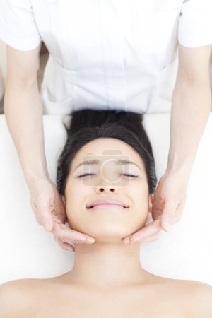 Photo for Beautiful asian woman getting facial massage at spa salon - Royalty Free Image