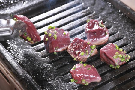 Photo for Beef steaks on grill with herbs and spices. - Royalty Free Image
