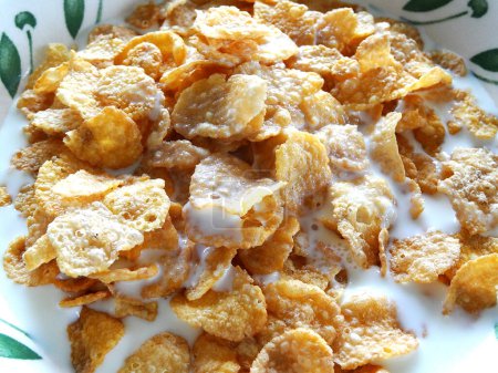Photo for Breakfast with crispy cornflakes and milk in the bowl - Royalty Free Image