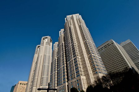 Photo for Low angle view of modern buildings in urban city against blue sky - Royalty Free Image