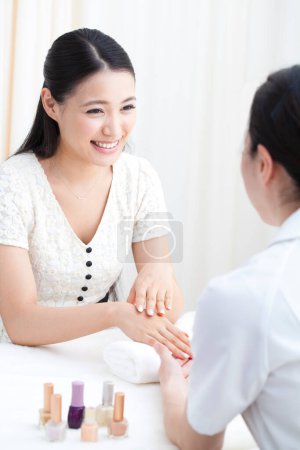 Photo for Young asian woman doing manicure in beauty salon - Royalty Free Image