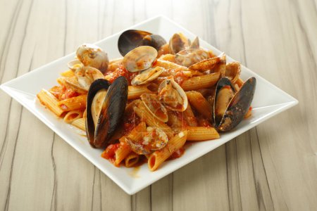 Photo for Spaghetti with mussels in tomato sauce, pasta with seafood on plate - Royalty Free Image