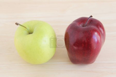 Photo for Close-up view of fresh ripe organic apples on wooden table. - Royalty Free Image