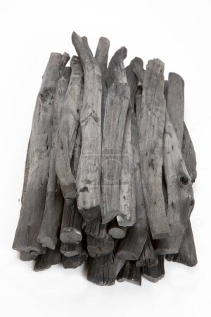 Photo for Close-up view of pile of charcoal sticks on white background - Royalty Free Image