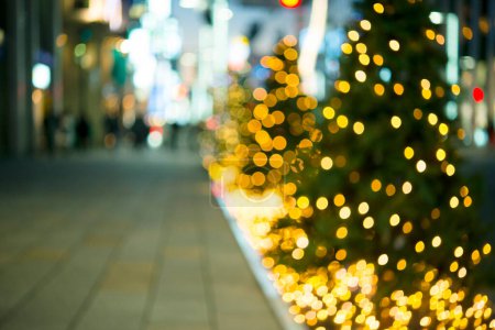 Photo for Blurred christmas tree and city lights on street - Royalty Free Image