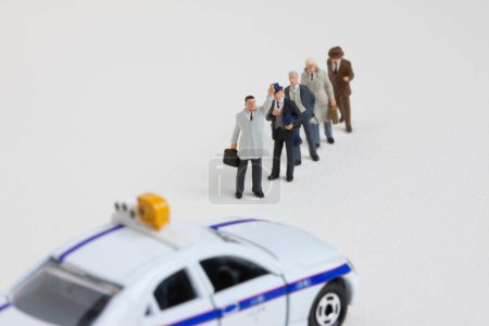 Photo for Row of miniature people standing and waiting for taxi - Royalty Free Image