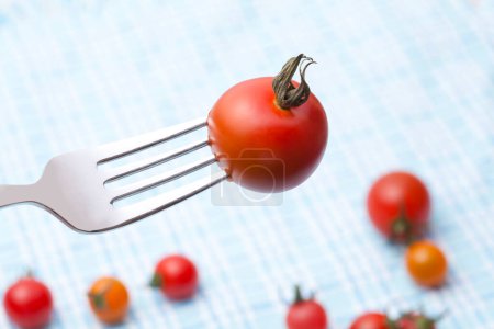 Photo for Close-up view of fresh ripe organic red tomatoes and fork - Royalty Free Image