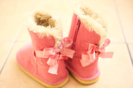Photo for Cute pink ugg boots on the floor - Royalty Free Image