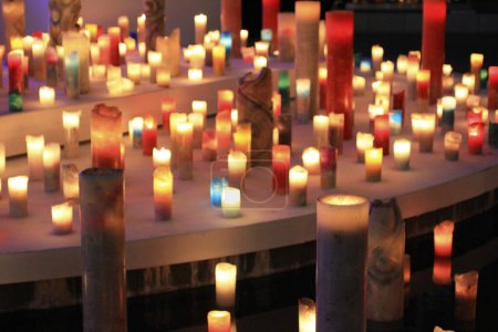 close-up view of many various burning candles in the night     