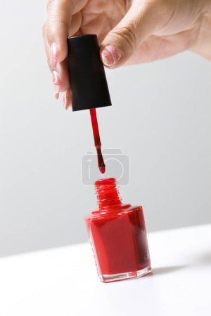 Photo for Red nail polish and  female hand. - Royalty Free Image