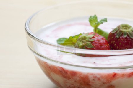Photo for Delicious dessert in glass bowl with yogurt and fresh strawberries - Royalty Free Image