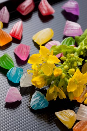 Foto de Vista de cerca de hermosas flores de primavera y dulces caramelos coloridos - Imagen libre de derechos