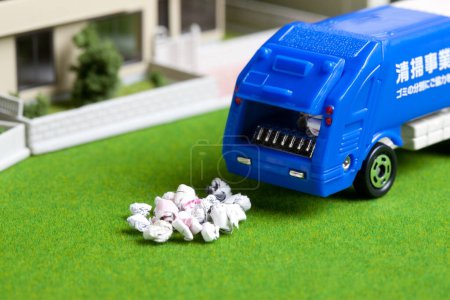 Photo for Miniature garbage truck collecting trash near house models - Royalty Free Image