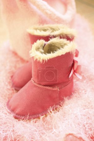 pink ugg boots on cozy fluffy blanket 