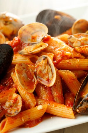 Photo for Spaghetti with mussels in tomato sauce, pasta with seafood on plate - Royalty Free Image