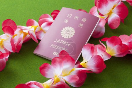Photo for Japan passport and red tropical flowers, vacation concept - Royalty Free Image