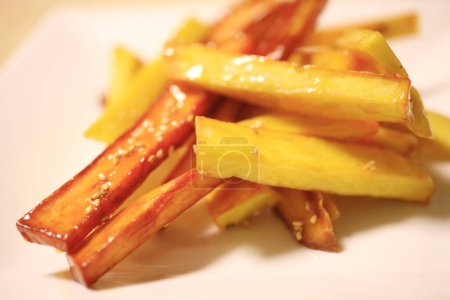 Photo for Close up of french fries, potatoes and carrots on plate - Royalty Free Image