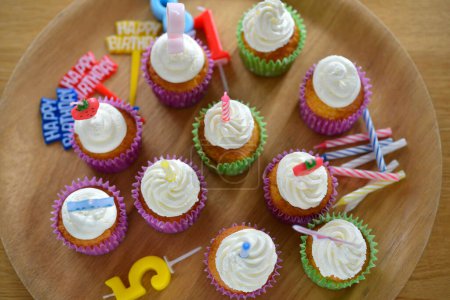 Foto de Deliciosos cupcakes de cumpleaños con crema y velas, primer plano - Imagen libre de derechos