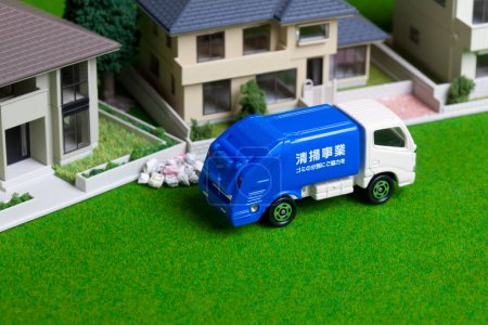 Photo for Garbage truck collecting trash near house models - Royalty Free Image