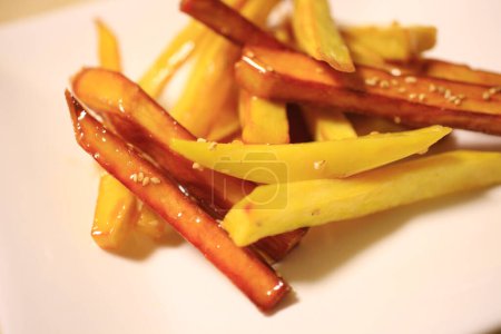 Photo for Close up of french fries, potatoes and carrots on plate - Royalty Free Image