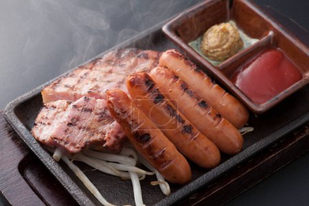 Photo for A cuisine photo of grilled pork, sausages and sauces - Royalty Free Image