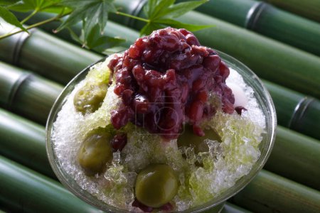Photo for Cold shaved Matcha ice with Boiled azuki beans and plums on background, close up - Royalty Free Image