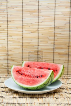Photo for Fresh sliced watermelon on white plate, close up - Royalty Free Image