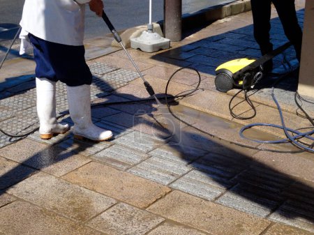 Photo for Cleaning of asphalt city street in Japan - Royalty Free Image