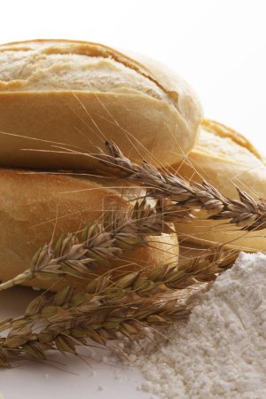 Photo for Bread and flour on a white background with wheat ears - Royalty Free Image