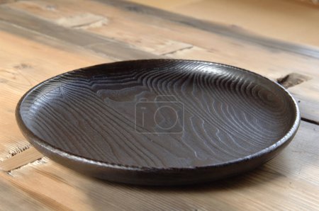 Photo for Black bowl on wooden background. - Royalty Free Image