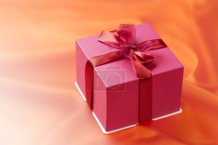Photo for A pink gift box with a red ribbon - Royalty Free Image
