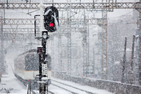 Téléchargez les photos : Train arrivant à la gare pendant les chutes de neige d'hiver - en image libre de droit