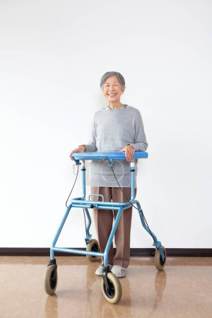 Photo for Smiling senior asian woman with walker - Royalty Free Image