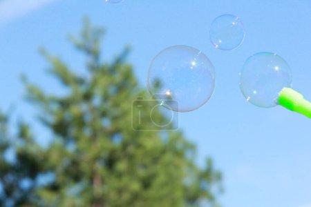 Photo for Close up shot of person blowing soap bubbles - Royalty Free Image