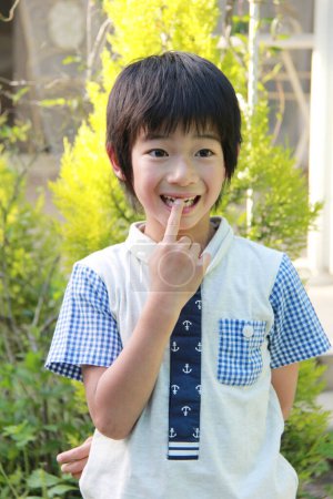 Photo for Cute Asian little boy smiling in summer garden - Royalty Free Image
