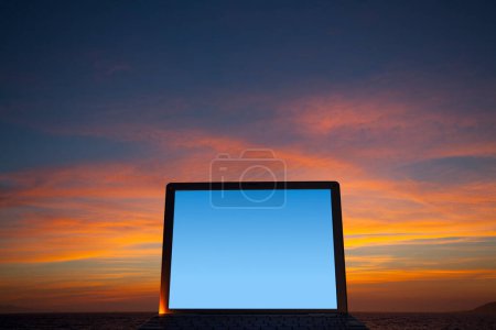 Foto de Ordenador portátil contra el fondo del cielo puesta del sol - Imagen libre de derechos