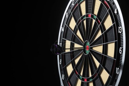 Photo for Dart arrow hitting in the target center of dartboard - Royalty Free Image