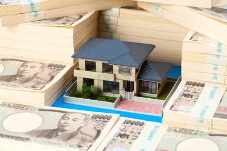 Photo for Japanese currency, pile of yen banknotes and house model - Royalty Free Image
