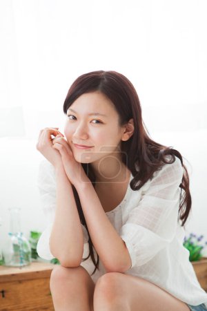 Photo for Portrait of beautiful young asian woman in light home interior - Royalty Free Image