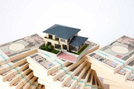 Photo for Japanese yen banknotes and small house model on background - Royalty Free Image