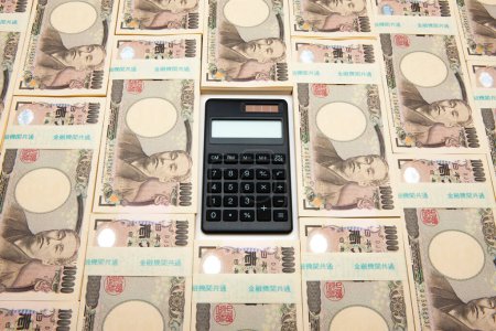 Foto de Calculadora con dinero del yen japonés en el fondo. - Imagen libre de derechos