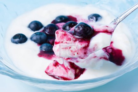 Photo for Yogurt with blueberries and berries in a glass bowl. - Royalty Free Image