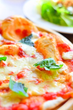Photo for Italian pizza with mozzarella, tomatoes and basil leaves - Royalty Free Image