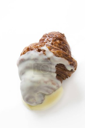 Photo for Close up of a croissant with cream on a white background - Royalty Free Image