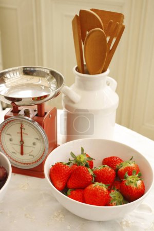 Photo for Fresh ripe strawberries and kitchen utensils on table - Royalty Free Image
