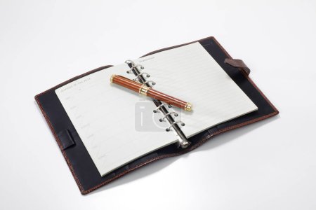 Photo for Leather notepad with pen on white background, close up - Royalty Free Image